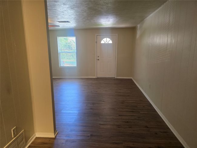 Entrance foyer featuring a textured ceiling and dark wood-style floors | Image 9