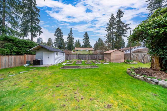 View of yard with a fenced backyard, a vegetable garden, an outbuilding, and a shed | Image 4