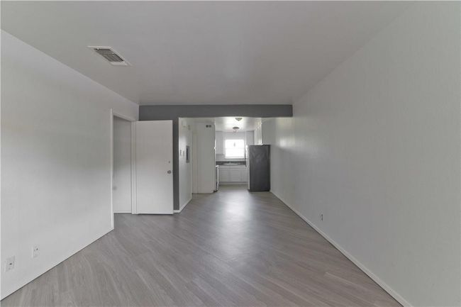 Spare room featuring light wood-type flooring | Image 4