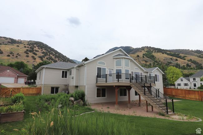 Rear view of property with stairway, a deck with mountain view, and a patio | Image 17