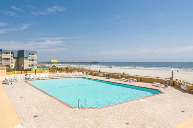 View of building exterior with a beach view and a water view | Image 26