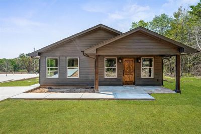 Come home to this perfect curb appeal! Solid wood door gives a rich look to the porch! | Image 2