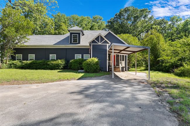 View of front of house featuring roof with shingles, a front lawn, aphalt driveway, and an attached carport | Image 8