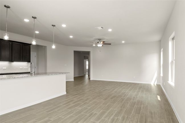 Unfurnished living room with ceiling fan, recessed lighting, and light wood-type flooring | Image 13
