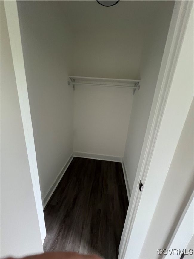 Spacious closet featuring dark wood-style flooring | Image 19