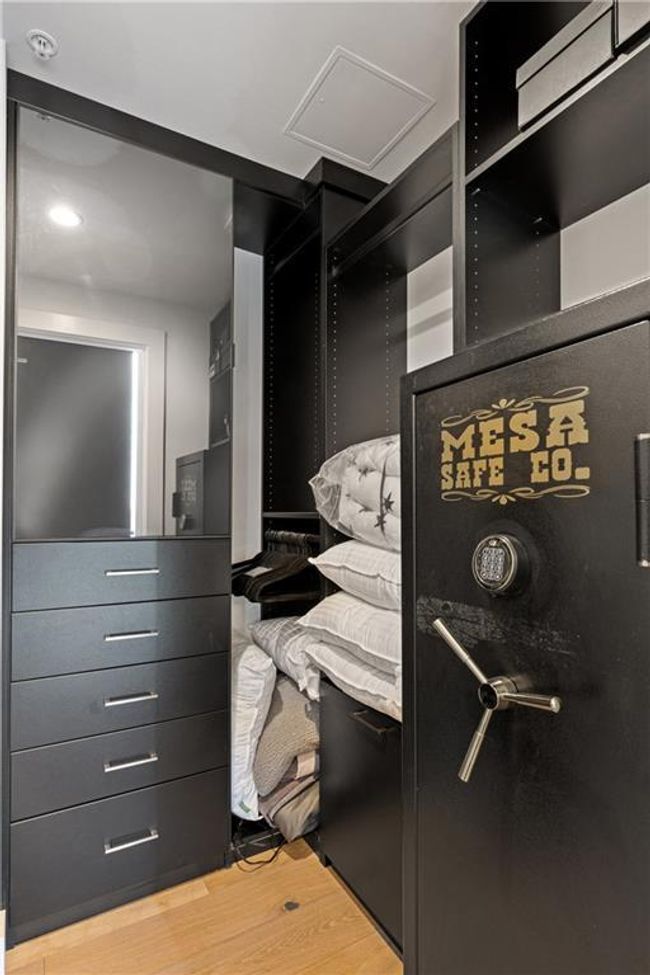 Spacious closet with attic access and light wood-type flooring | Image 7
