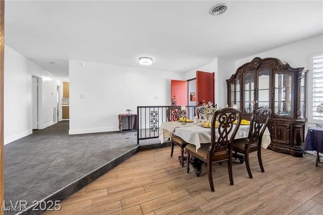 Dining space featuring wood finished floors and baseboards | Image 9