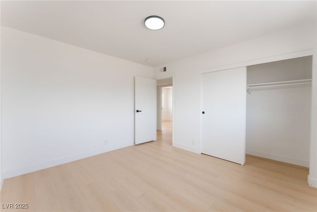 Unfurnished bedroom with light wood finished floors and a closet | Image 47