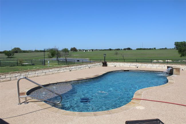 View of pool featuring a fenced in pool, a patio, a fenced backyard, and a rural view | Image 20