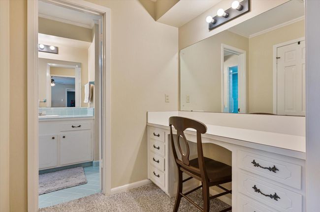 Dressing area with vanity between primary bedroom and bath | Image 34