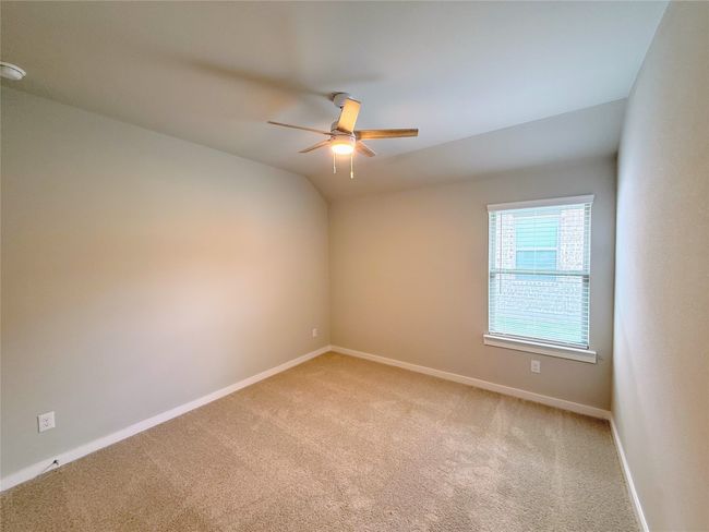 Spare room featuring light colored carpet, a ceiling fan, and baseboards | Image 21