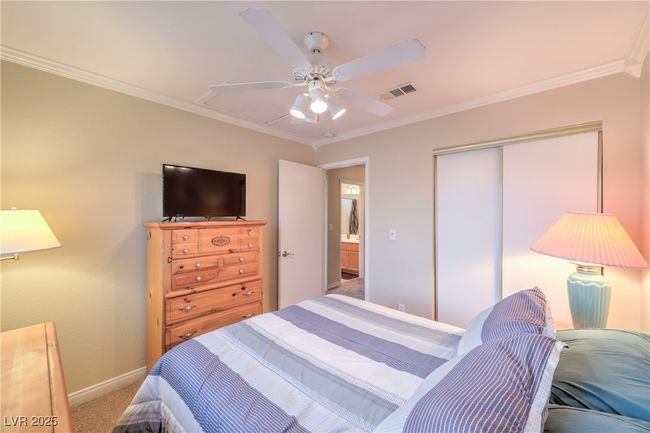 Carpeted bedroom featuring a closet, ornamental molding, and a ceiling fan | Image 12