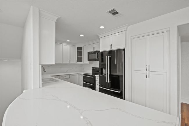 Sleek Quartz Countertops and custom cabinetry and pantry | Image 11