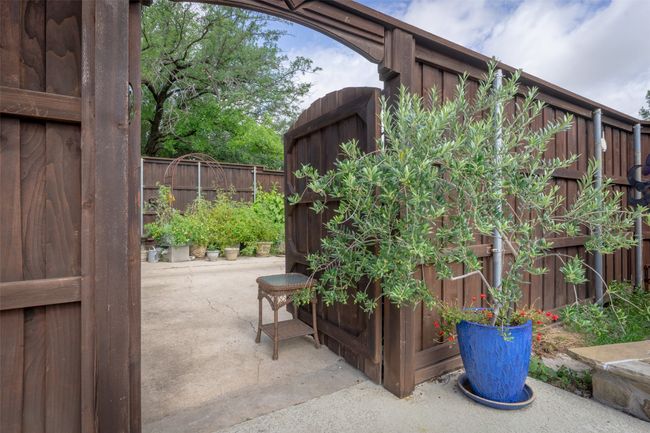 Fenced backyard with a patio | Image 32