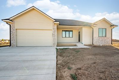 Ranch-style home featuring a garage | Image 1