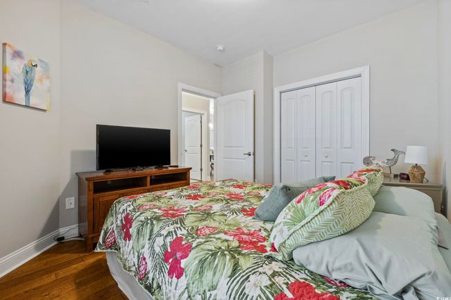 Bedroom featuring dark wood-type flooring, a closet, and baseboards | Image 21
