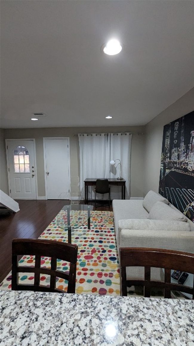 Living area with wood finished floors and recessed lighting | Image 8