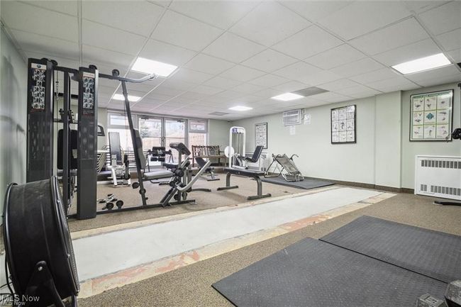 Gym featuring radiator heating unit, baseboards, and a paneled ceiling | Image 5