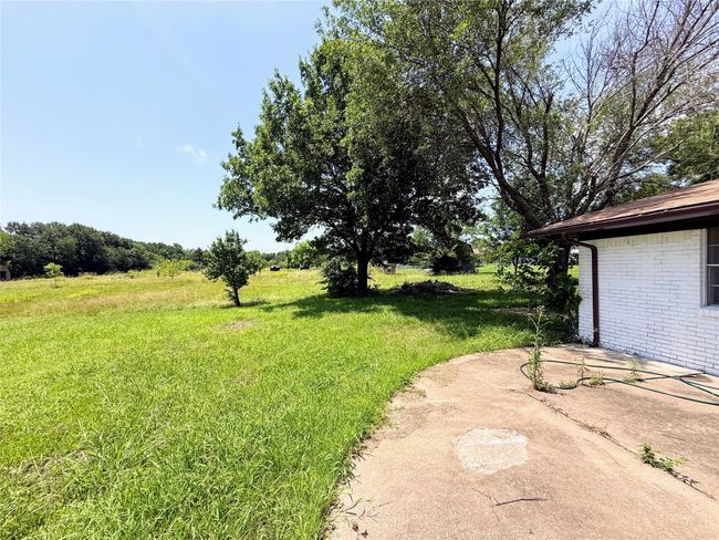 View of grassy yard featuring a patio | Image 26