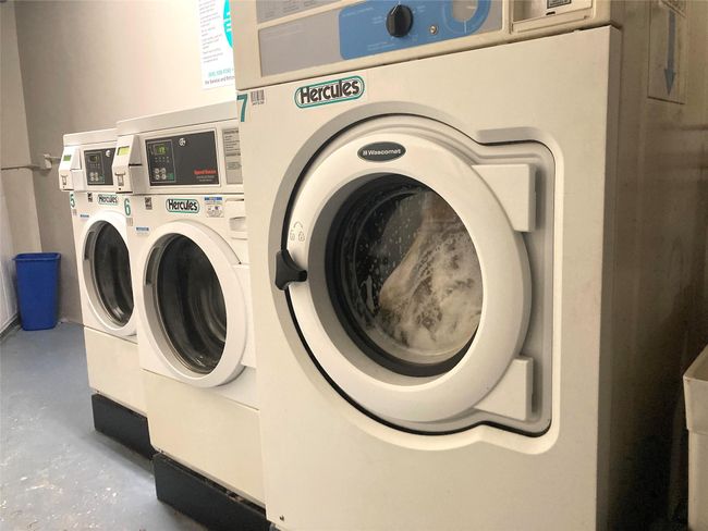 Shared laundry room featuring independent washer and dryer | Image 21