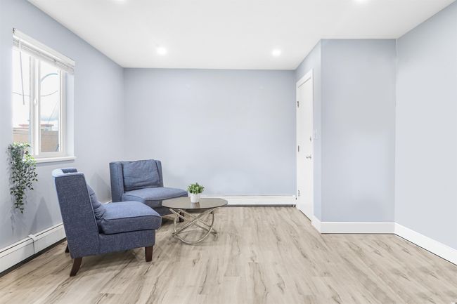 Living area with baseboards, wood finished floors, and recessed lighting | Image 11