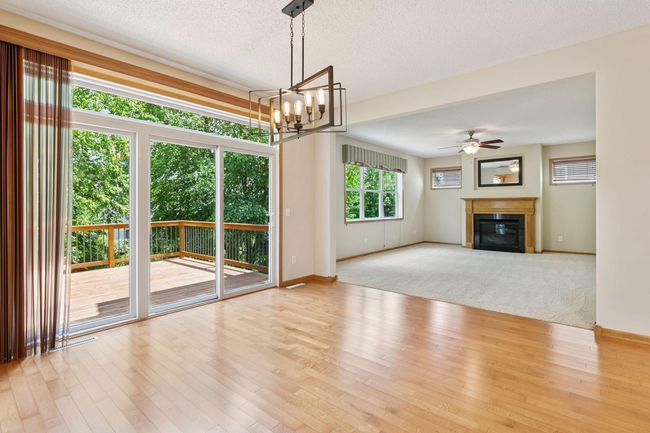 The dining room has hardwood floors and opens onto the deck | Image 4