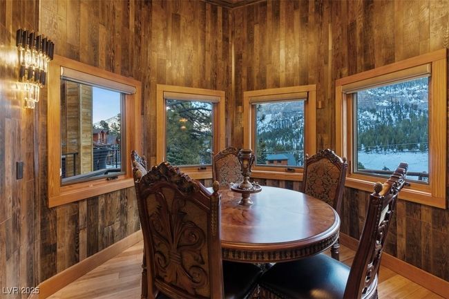 Dining space featuring a wealth of natural light and wood walls | Image 36