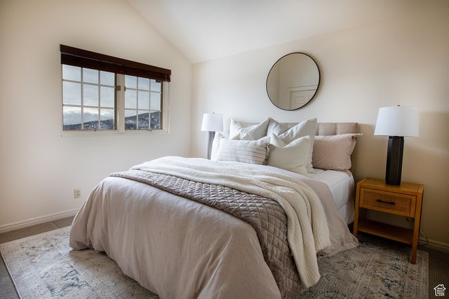 Bedroom with vaulted ceiling, light colored carpet, and baseboards | Image 11