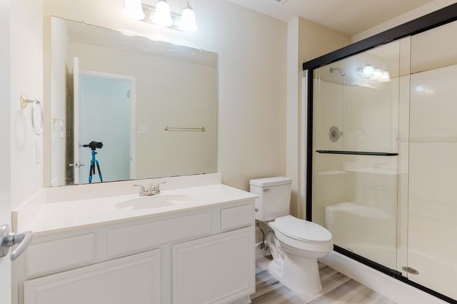 Full bathroom featuring toilet, a stall shower, wood finished floors, and vanity | Image 18