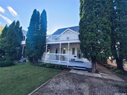 Two-story exterior with a second-level balcony and a covered porch | Card Image