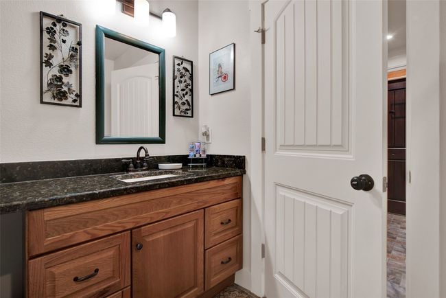 The main bathroom also has dark rich colors bring warmth to the area. | Image 27