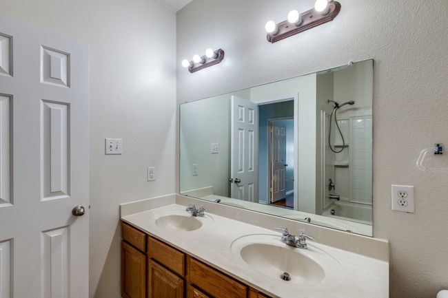 Bathroom featuring a sink, double vanity, and shower / bath combination | Image 21