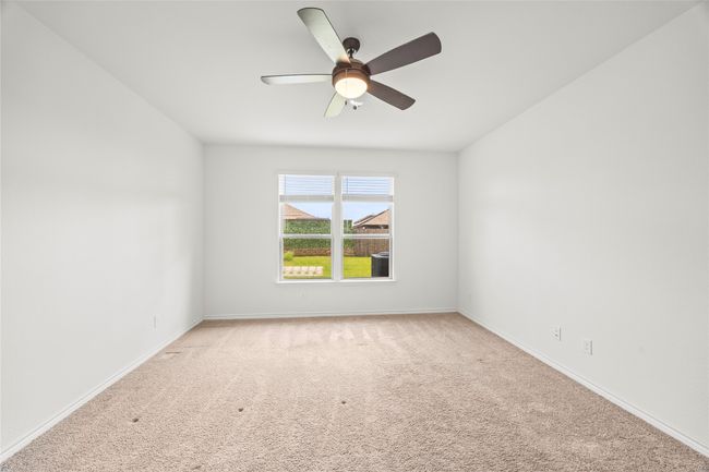 Empty room featuring light carpet, a ceiling fan, and baseboards | Image 21