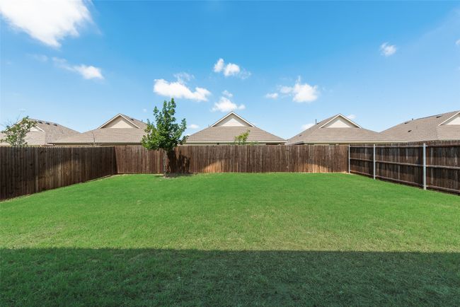 View of fenced backyard | Image 24