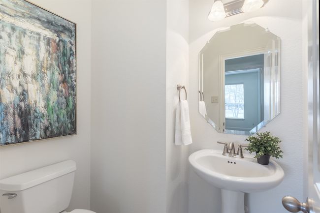 Half bathroom with toilet and a sink | Image 15