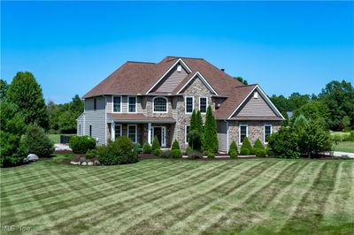 View of front facade with a front lawn | Image 1