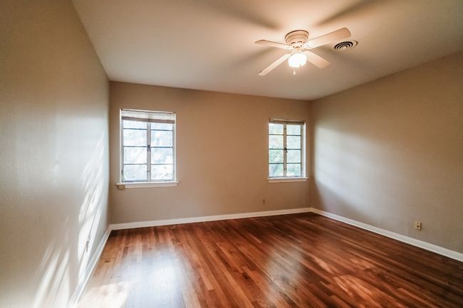 Empty room featuring dark wood-style floors and ceiling fan | Image 19