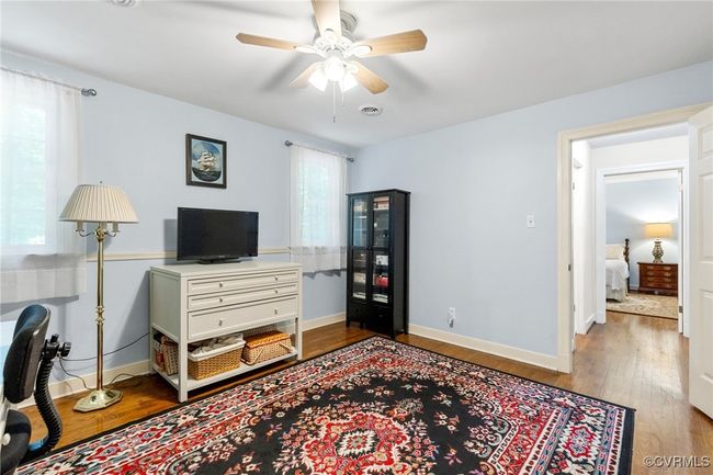 Office space with a ceiling fan and wood finished floors | Image 28