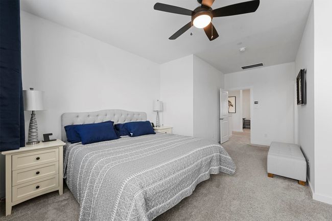Carpeted bedroom featuring ceiling fan | Image 17