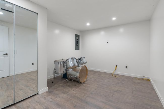 Unfurnished room featuring electric panel, recessed lighting, baseboards, and wood finished floors | Image 25