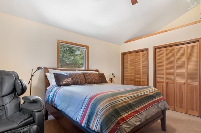 Spacious Bedroom with ceiling fan, multiple closets, and lofted ceiling. Located on main level. | Image 52