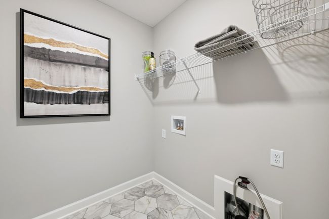 (Photo of decorated model, actual home's finishes will vary) Centrally located on the upper level, along with the three bedrooms, this laundry room is sure to provide the ultimate convenience. | Image 20