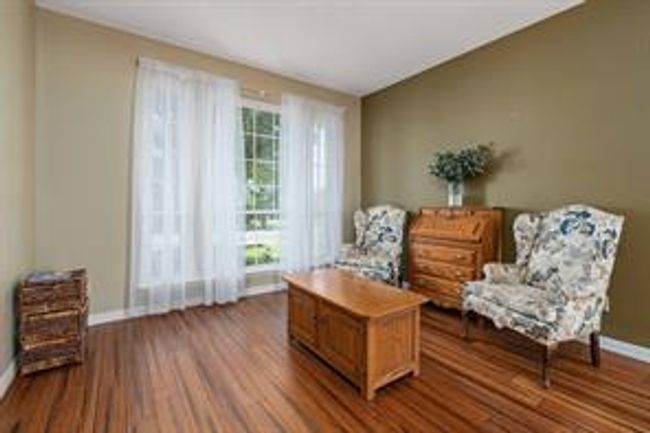 Sitting room with baseboards and dark wood finished floors | Image 15
