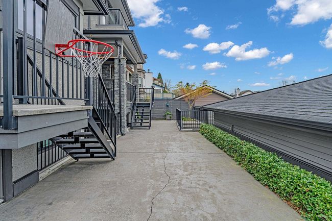 View of home's exterior featuring stairway, fence, a residential view, and a patio | Image 6