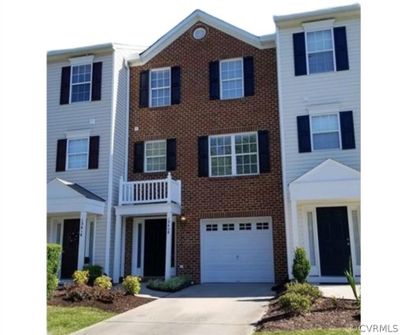 View of front facade featuring a garage and a balcony | Image 1