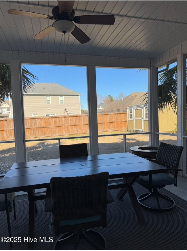 Large screened-in porch over looking the fenced-in backyard and 10 x 12 storage building that renters can utilize. | Image 5