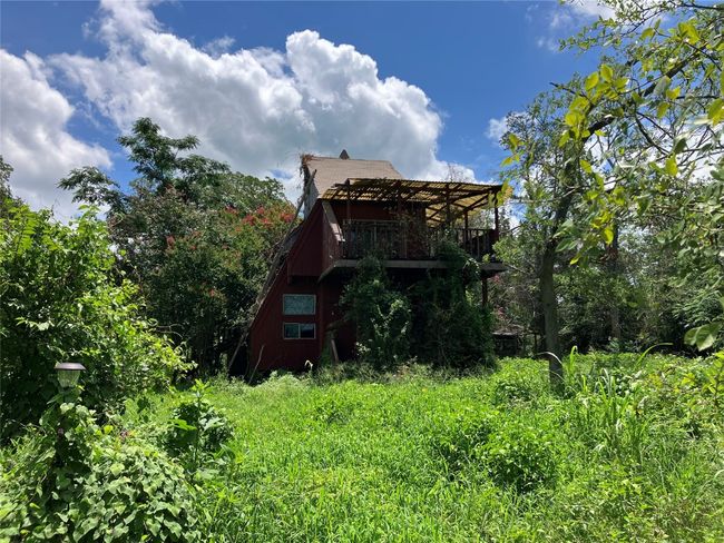 A-Frame House in need of repair or removal. Property is secluded with mature native trees. | Image 11