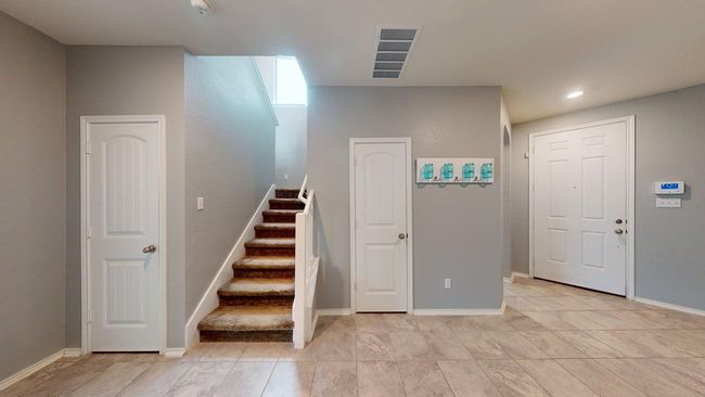 Staircase featuring baseboards, recessed lighting, and visible vents | Image 11