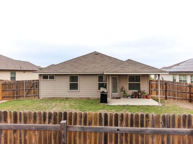 Back of house featuring a yard, a fenced backyard, a patio, and roof with shingles | Image 22