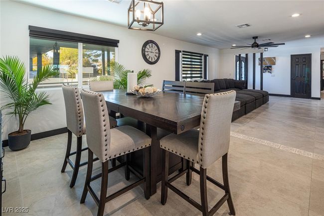 Dining area featuring visible vents, recessed lighting, ceiling fan with notable chandelier, and baseboards | Image 17
